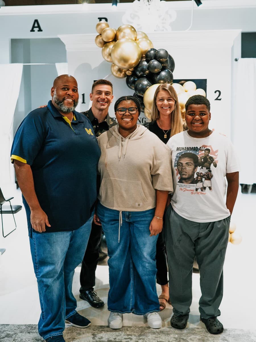 Dr. Tim and Dr. Amanda celebrating with a patient family at Limitless Chiropractic