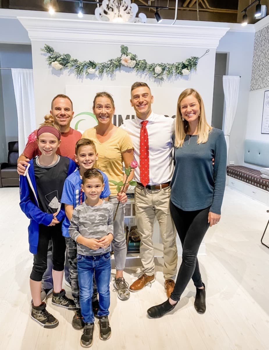 Dr. Tim and Dr. Amanda with a patient family in the Limitless Chiropractic clinic in Ballantyne, Charlotte NC